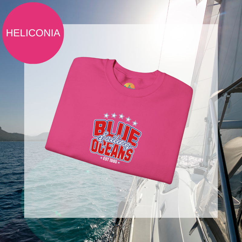 Pink sweatshirt featuring the text 'Blue Sailing Oceans - Est. 1990' in bold red and white with star accents, perfect for nautical enthusiasts.