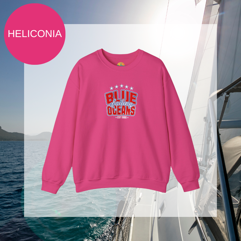 Pink sweatshirt featuring the text 'Blue Sailing Oceans - Est. 1990' in bold red and white with star accents, perfect for nautical enthusiasts.