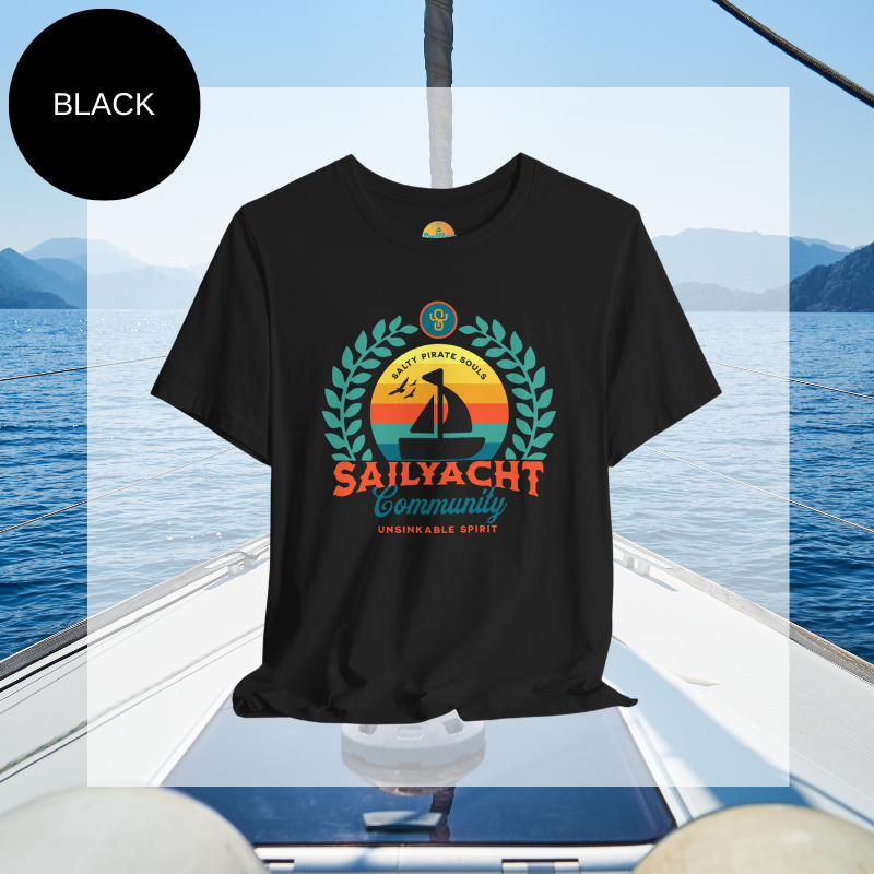 Black unisex t-shirt featuring a vibrant 'Sailyacht Community' design with a sailboat, laurel wreath, and retro sunset, displayed on a yacht deck background.
