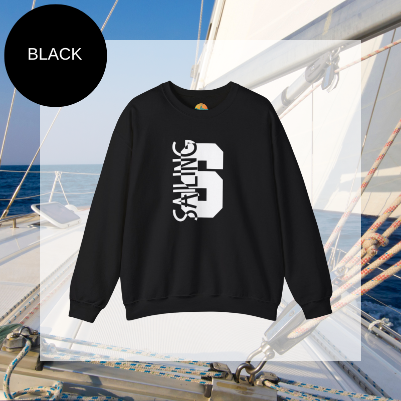 Black sweatshirt featuring a bold vertical 'S' with the word 'SAILING' integrated into the design, displayed on a sailboat deck with ocean and sky in the background.