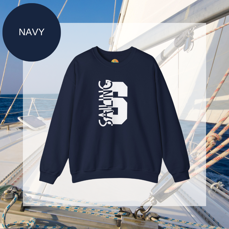 Black sweatshirt featuring a bold vertical 'S' with the word 'SAILING' integrated into the design, displayed on a sailboat deck with ocean and sky in the background.