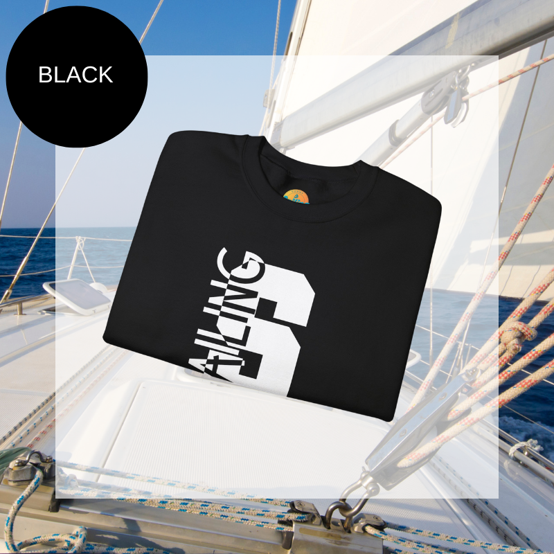 Black sweatshirt featuring a bold vertical 'S' with the word 'SAILING' integrated into the design, displayed on a sailboat deck with ocean and sky in the background.