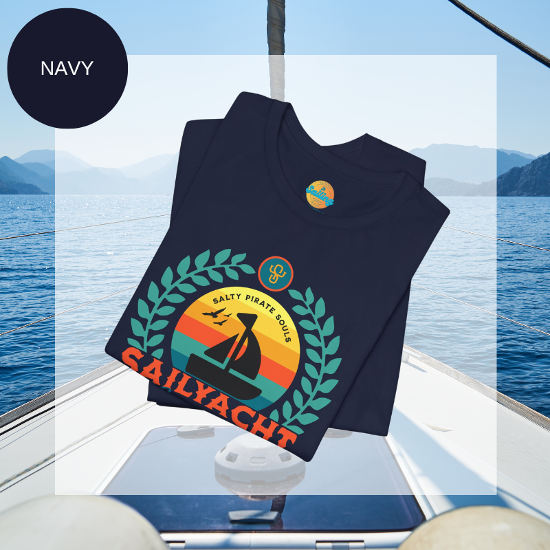 Navy blue unisex t-shirt featuring a vibrant 'Sailyacht Community' design with a sailboat, laurel wreath, and retro sunset, displayed on a yacht deck background.