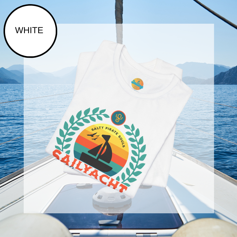 White unisex t-shirt featuring a vibrant 'Sailyacht Community' design with a sailboat, laurel wreath, and retro sunset, displayed on a yacht deck background.