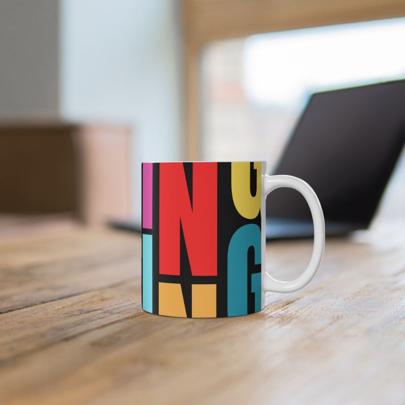 Colorful coffee mug with a bold, artistic 'SAILING' typography design, perfect for adding a vibrant nautical touch to your morning routine or gifting to sailing enthusiasts.