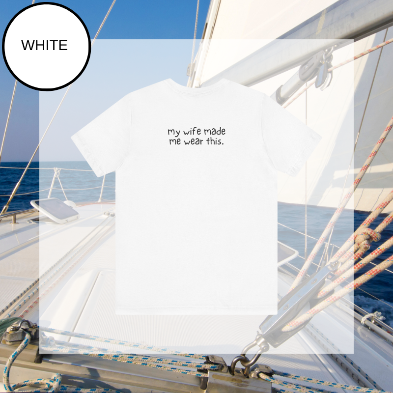 White t-shirt featuring the text 'Best Salty Dog Dad Ever' in playful fonts. The design includes an illustration of a cute dog's face peeking over the words, combining nautical and pet-loving themes. The background showcases a serene sailing scene with ropes and a yacht deck.