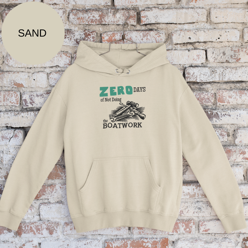 Sand colored hoodie featuring the humorous sailing-themed text 'ZERO DAYS of Not Doing the BOATWORK,' ideal for passionate boaters who embrace the never-ending tasks of boat maintenance.