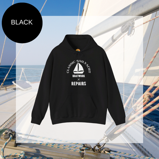 Black hoodie with a 'Classic Sail Yacht' design featuring a sailboat and the text 'Boatwork x Repairs,' perfect for sailing enthusiasts who appreciate the charm of yacht maintenance.