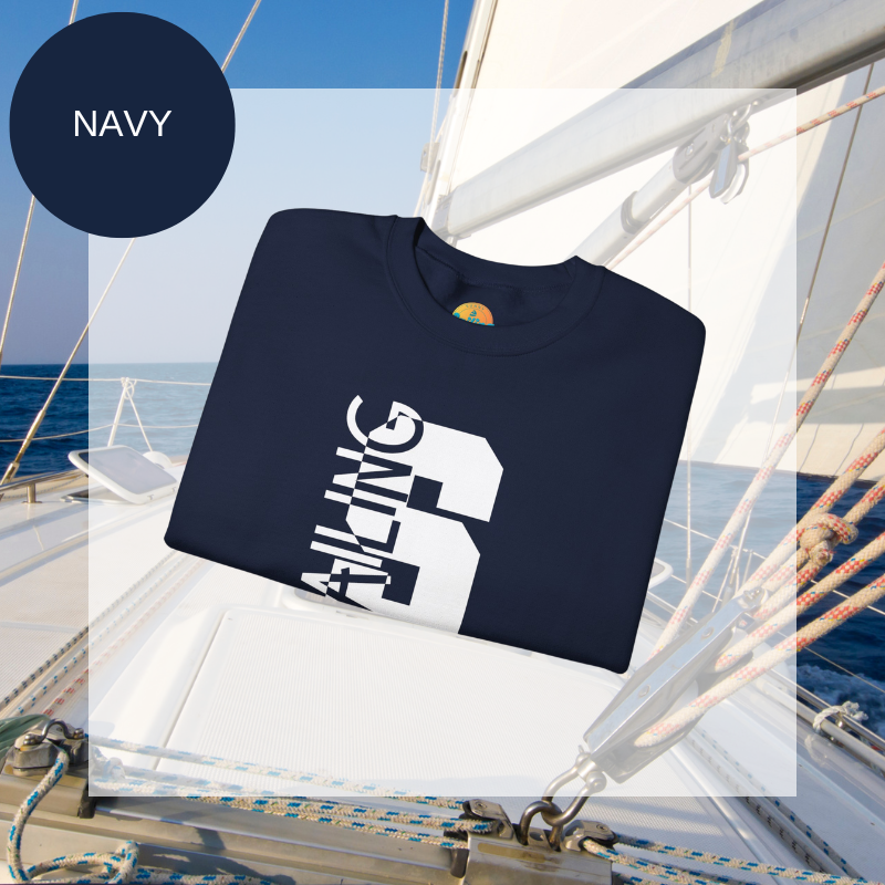 Black sweatshirt featuring a bold vertical 'S' with the word 'SAILING' integrated into the design, displayed on a sailboat deck with ocean and sky in the background.