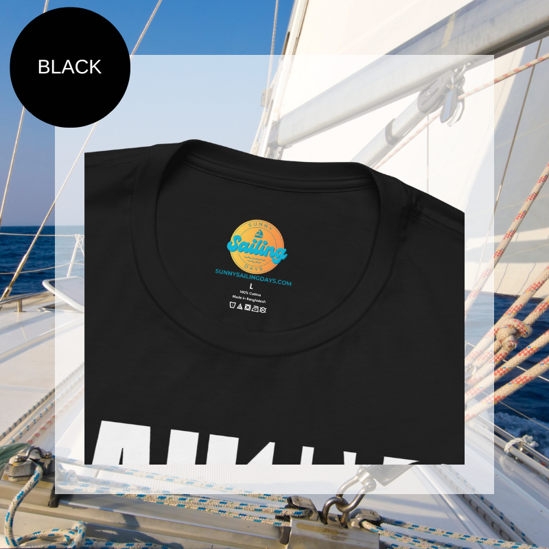 Black unisex t-shirt with bold white text design reading 'Sailing Sailing,' displayed on a yacht deck with a nautical background.