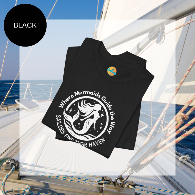 Black unisex t-shirt featuring a whimsical mermaid design with the text 'Where Mermaids Guide the Way, Sailors Find Their Haven,' displayed on a yacht deck background.