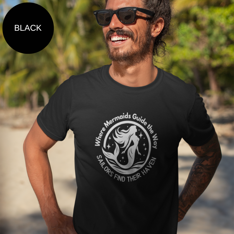 Black unisex t-shirt featuring a whimsical mermaid design with the text 'Where Mermaids Guide the Way, Sailors Find Their Haven,' displayed on a yacht deck background.