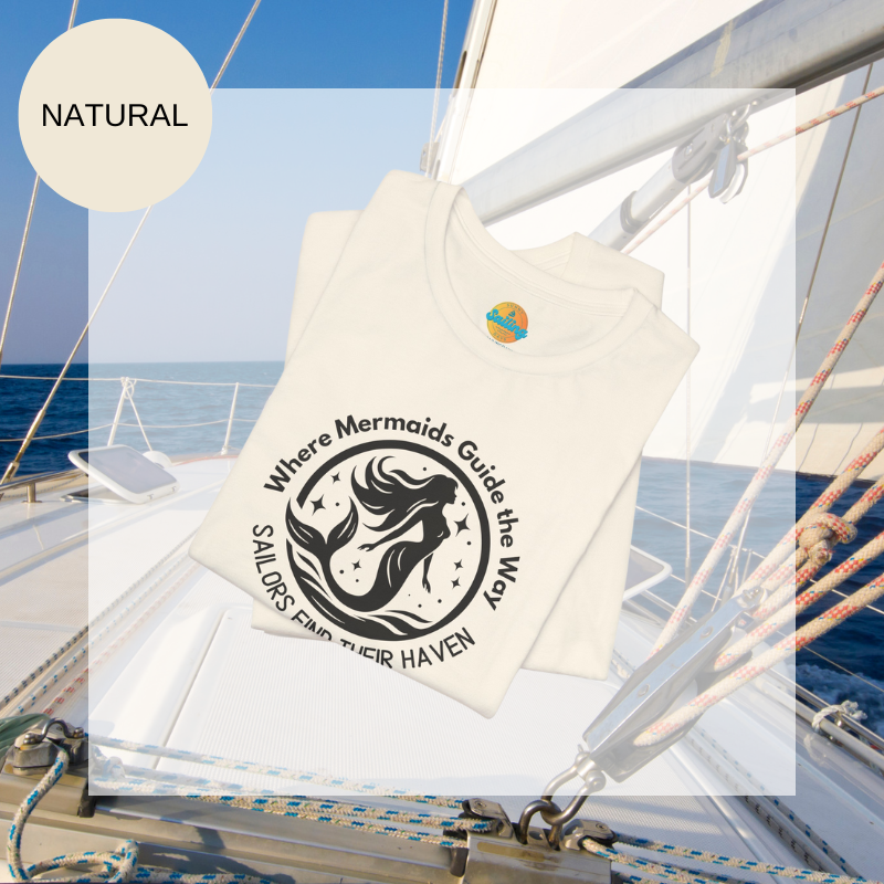 Natural white unisex t-shirt featuring a whimsical mermaid design with the text 'Where Mermaids Guide the Way, Sailors Find Their Haven,' displayed on a yacht deck background.