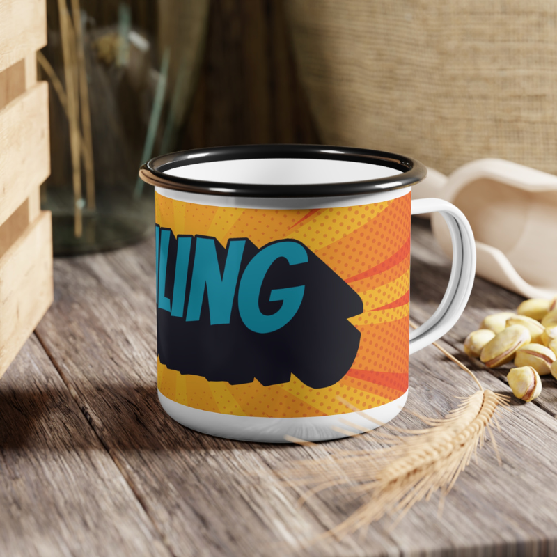 Vibrant enamel mug featuring a bold comic-style design with the text 'SAILING' in bright blue on an orange and yellow burst background, displayed on a sailboat deck with a serene ocean and mountain view in the background.