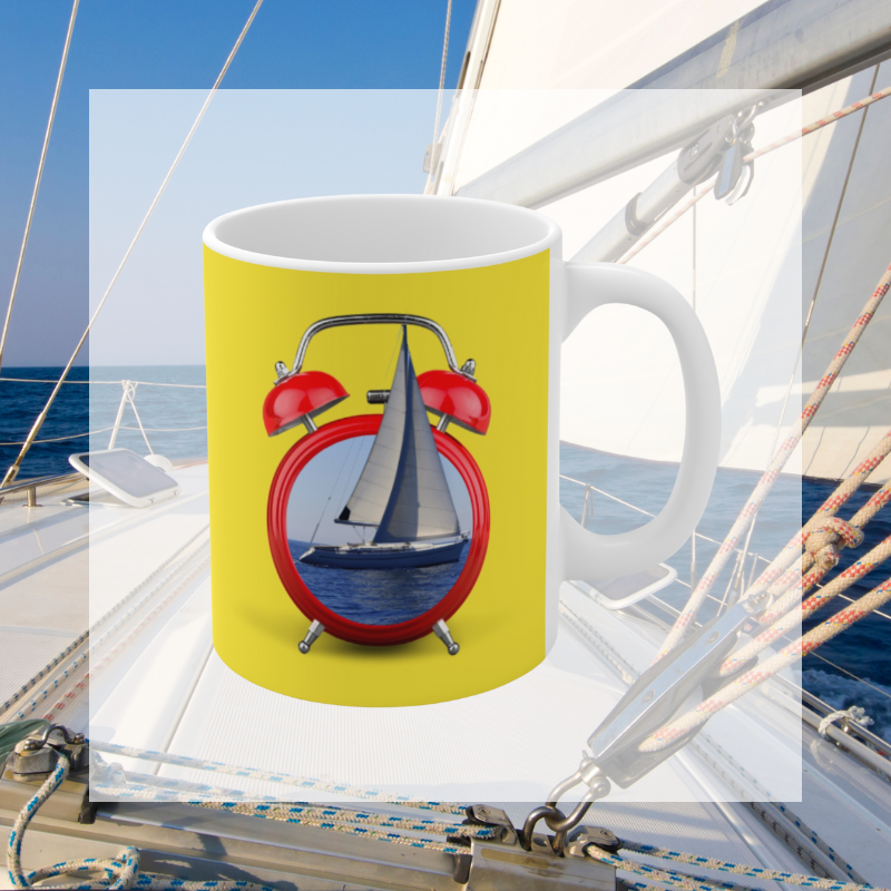Bright yellow coffee mug featuring the playful text 'It's Sailing O'Clock!' and an alarm clock design with a sailboat inside, perfect for sailing enthusiasts ready to set sail at any time