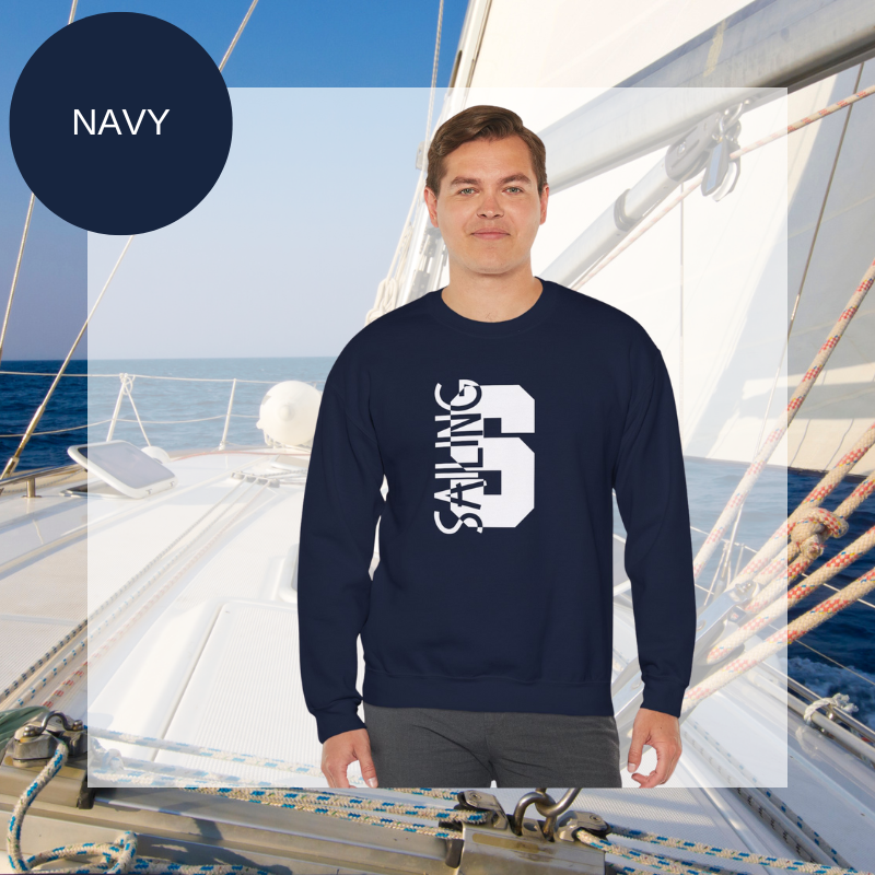 Black sweatshirt featuring a bold vertical 'S' with the word 'SAILING' integrated into the design, displayed on a sailboat deck with ocean and sky in the background.