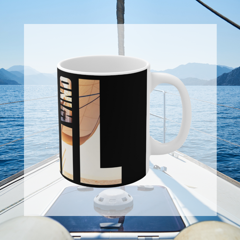Black coffee mug with bold typography spelling 'SAIL OCEAN WIND,' featuring a vibrant image of a sailboat bathed in warm sunlight, perfect for sailing enthusiasts.