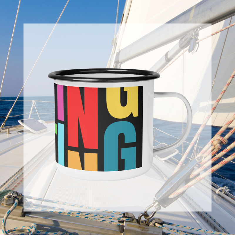 Colorful enamel mug with bold, vibrant 'SAILING' text design in a modern block font, perfect for nautical enthusiasts and lovers of bright, eye-catching patterns, captured against a serene sailing backdrop.