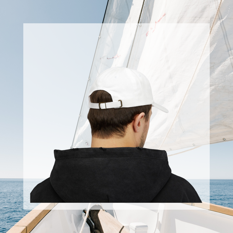 White dad cap featuring bold embroidered text 'SAIL,' perfect for sailors and sailing enthusiasts.
