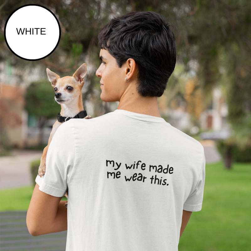 White t-shirt featuring the text 'Best Salty Dog Dad Ever' in playful fonts. The design includes an illustration of a cute dog's face peeking over the words, combining nautical and pet-loving themes. The background showcases a serene sailing scene with ropes and a yacht deck.