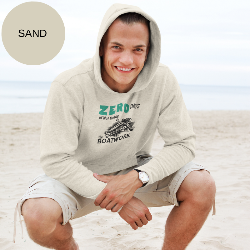 Sand colored hoodie featuring the humorous sailing-themed text 'ZERO DAYS of Not Doing the BOATWORK,' ideal for passionate boaters who embrace the never-ending tasks of boat maintenance.