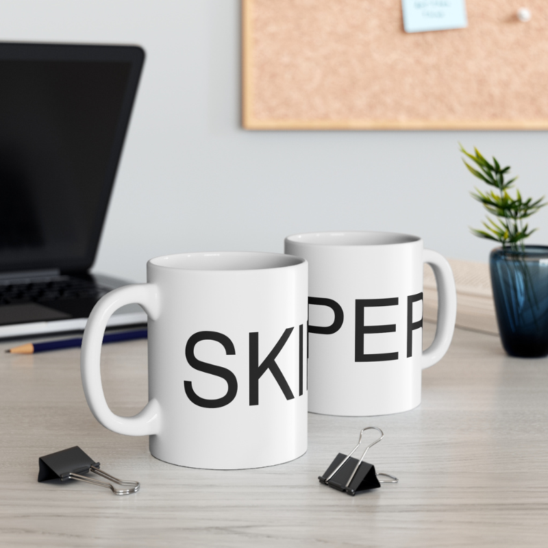 Minimalistic white coffee mug featuring bold black text that reads 'SKIPPER,' perfect for sailors and nautical enthusiasts