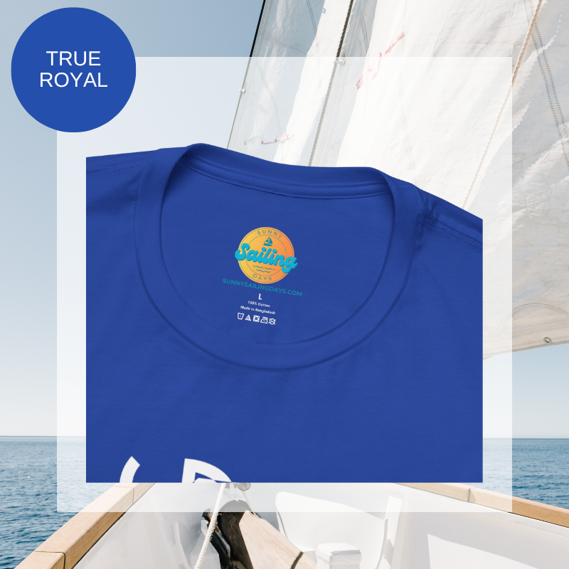 Royal blue unisex t-shirt with a bold white 'Sailing S' design, photographed on a sleek yacht deck with open sea in the background.