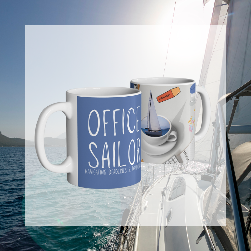 Blue coffee mug with the text 'Office Sailor: Navigating Deadlines & Daydreams,' featuring a playful design of a sailboat inside a coffee cup, perfect for combining work vibes with sailing dreams