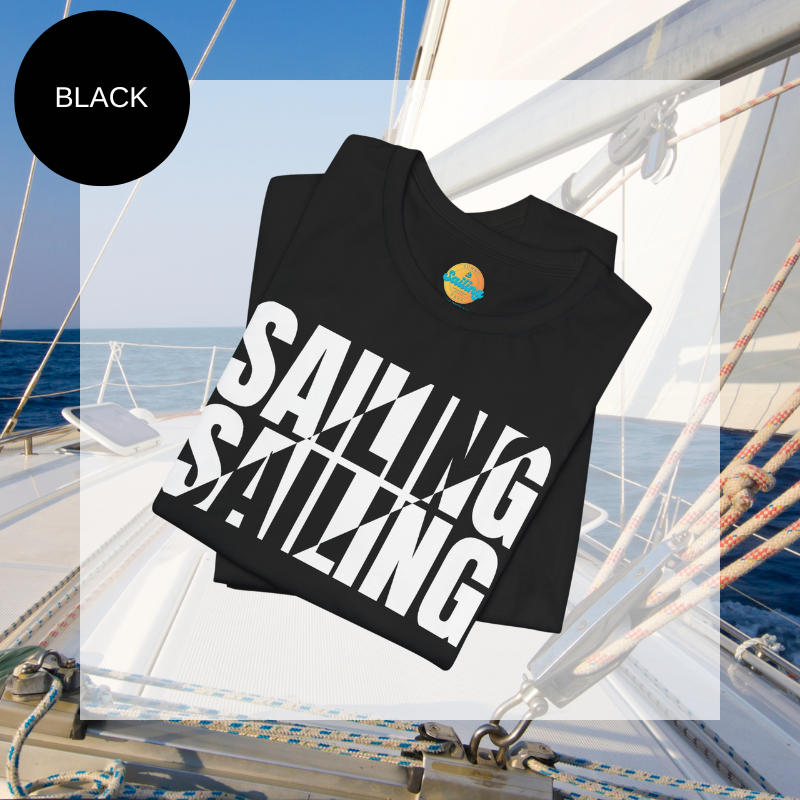 Black unisex t-shirt with bold white text design reading 'Sailing Sailing,' displayed on a yacht deck with a nautical background.