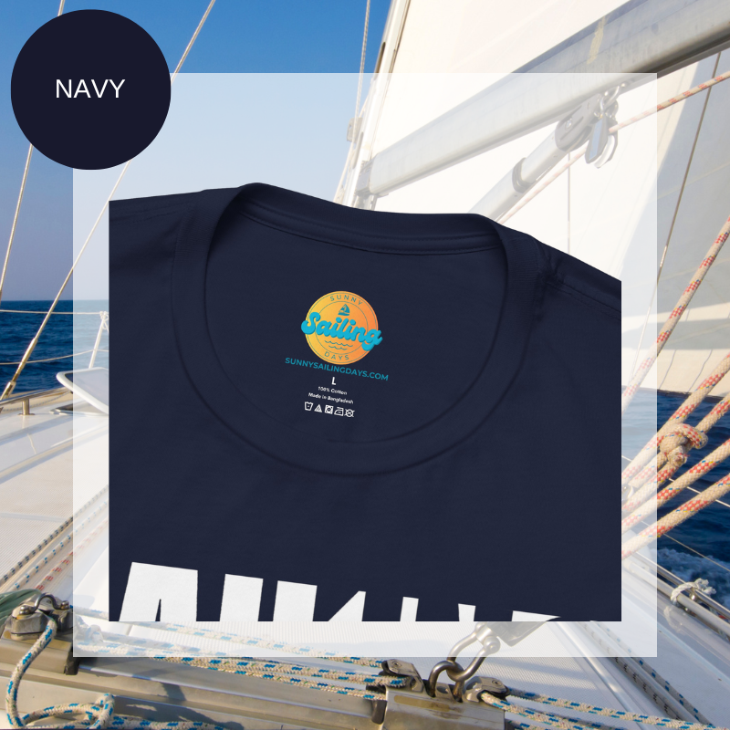 Navy unisex t-shirt with bold white text design reading 'Sailing Sailing,' displayed on a yacht deck with a nautical background.