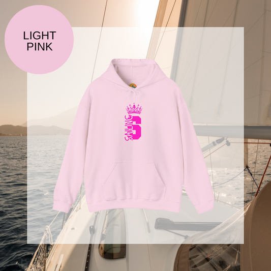 Light pink hoodie featuring a bold design with the word 'Sailing' and a crown graphic, perfect for expressing nautical style with a touch of elegance.