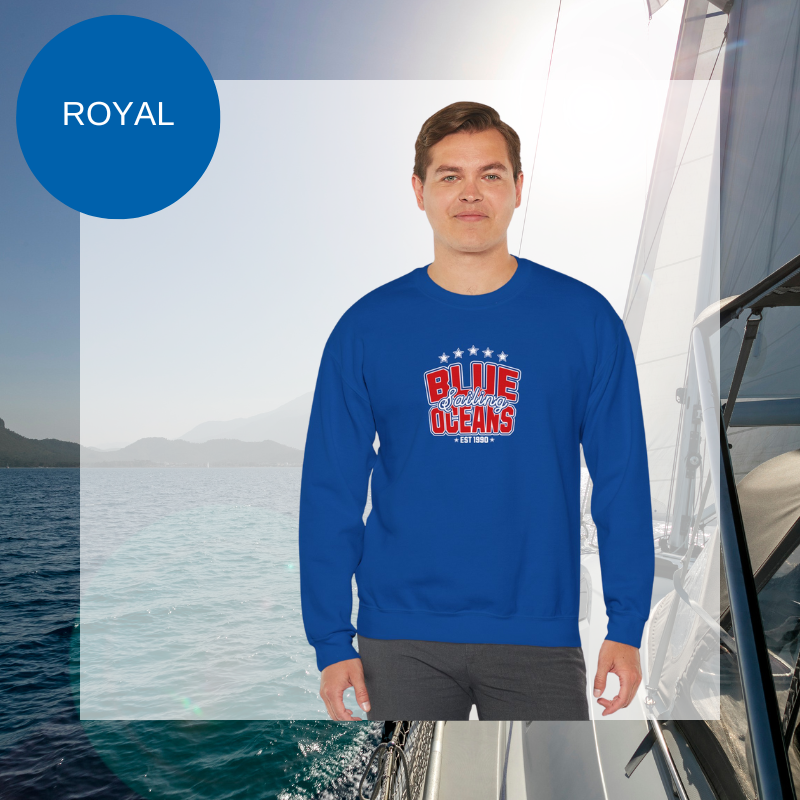 Navy blue sweatshirt featuring the text 'Blue Sailing Oceans - Est. 1990' in bold red and white with star accents, perfect for nautical enthusiasts.