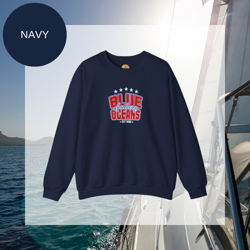 Navy blue sweatshirt featuring the text 'Blue Sailing Oceans - Est. 1990' in bold red and white with star accents, perfect for nautical enthusiasts.