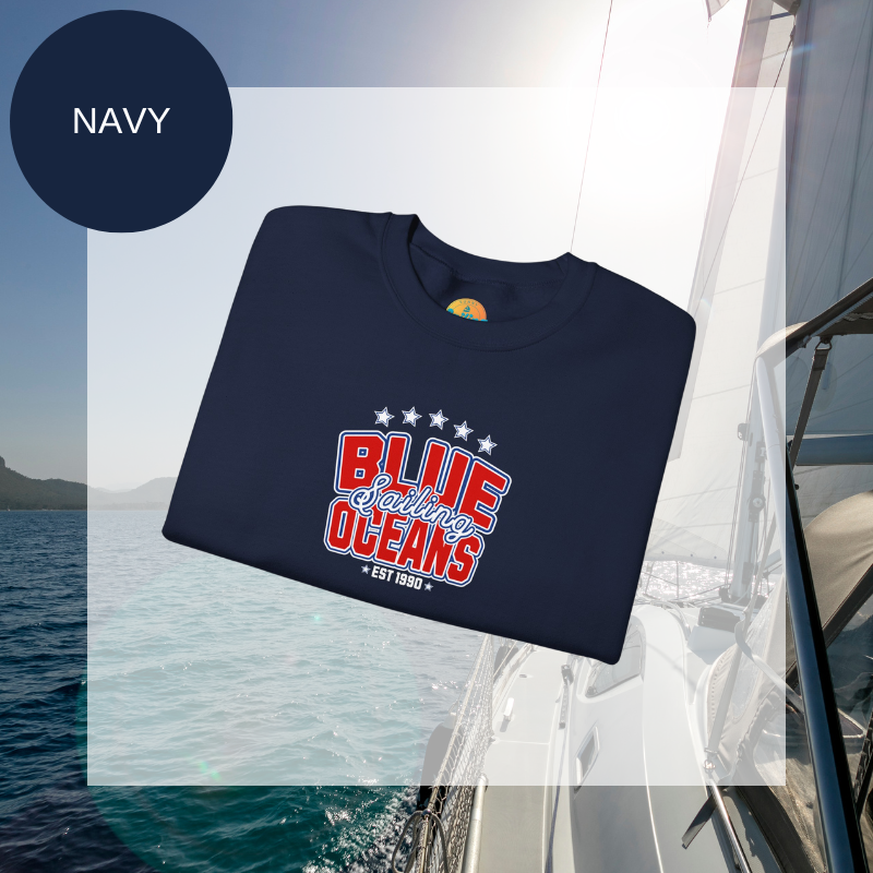 Navy blue sweatshirt featuring the text 'Blue Sailing Oceans - Est. 1990' in bold red and white with star accents, perfect for nautical enthusiasts.