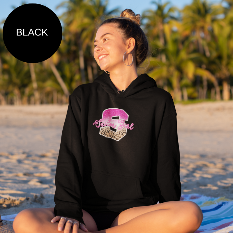 Black hoodie featuring a bold 'S' design with pink glitter and leopard print accents, along with the text 'Sailor Girl' in an elegant script font, perfect for nautical enthusiasts with a chic style.